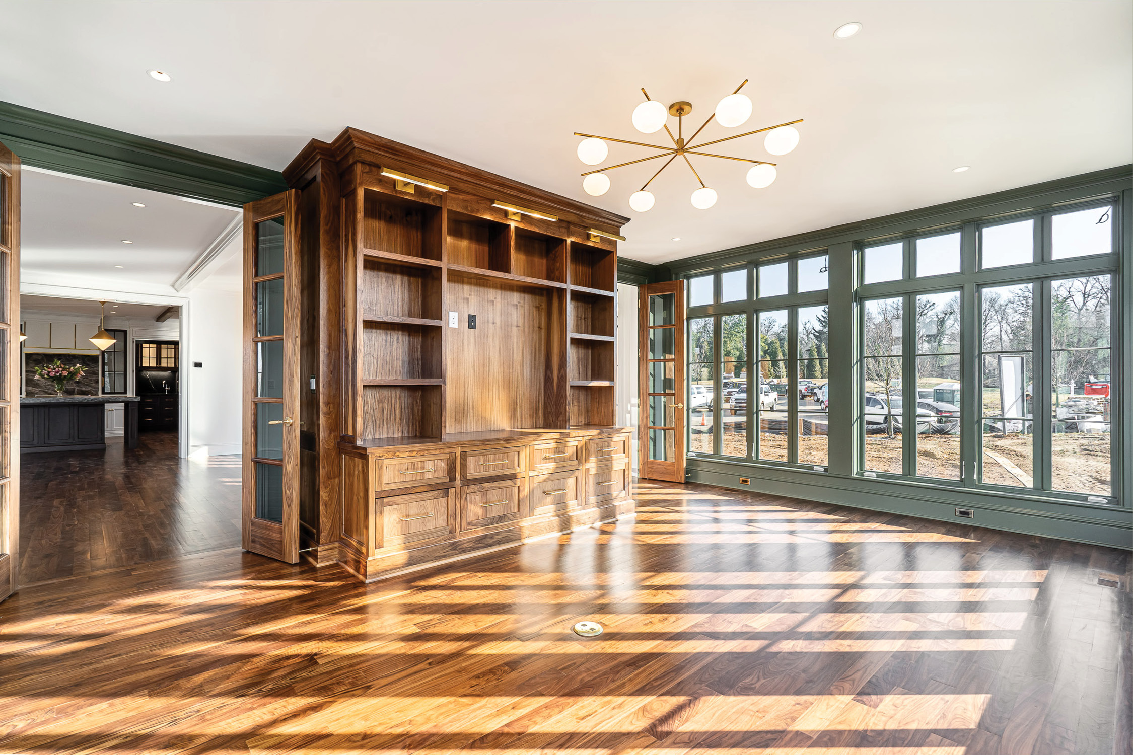 Sunroom with walnut built-in cabinetry and windows on three sides